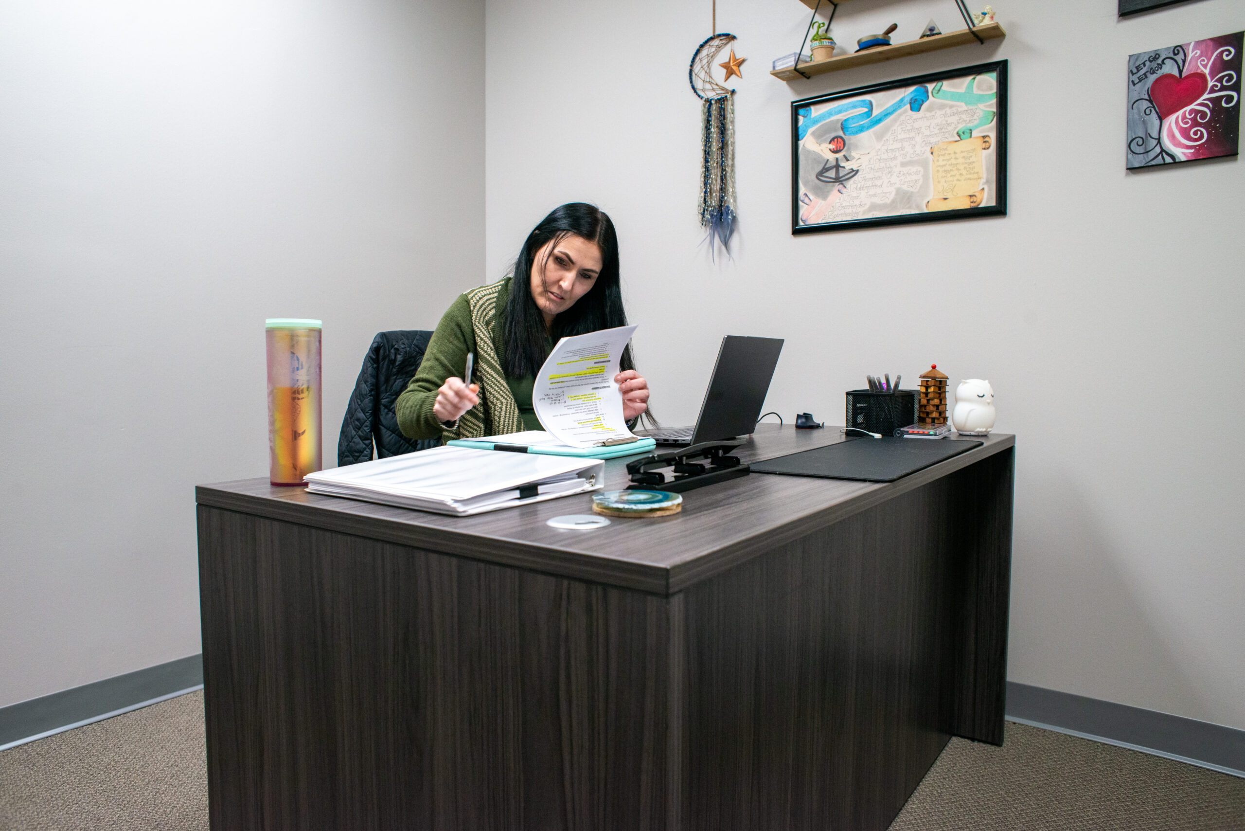 Woman studying notes at a desk.