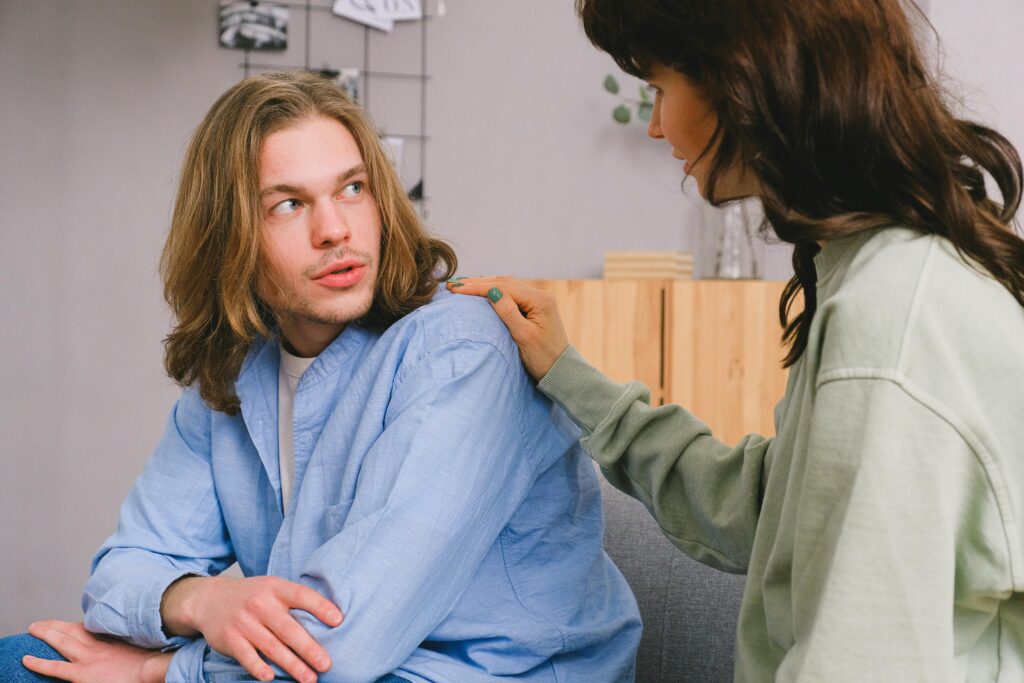A woman consoling her male friend.
