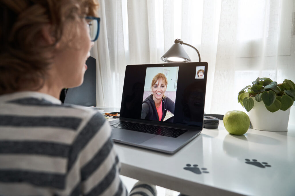 A person in a virtual therapy session on their laptop.