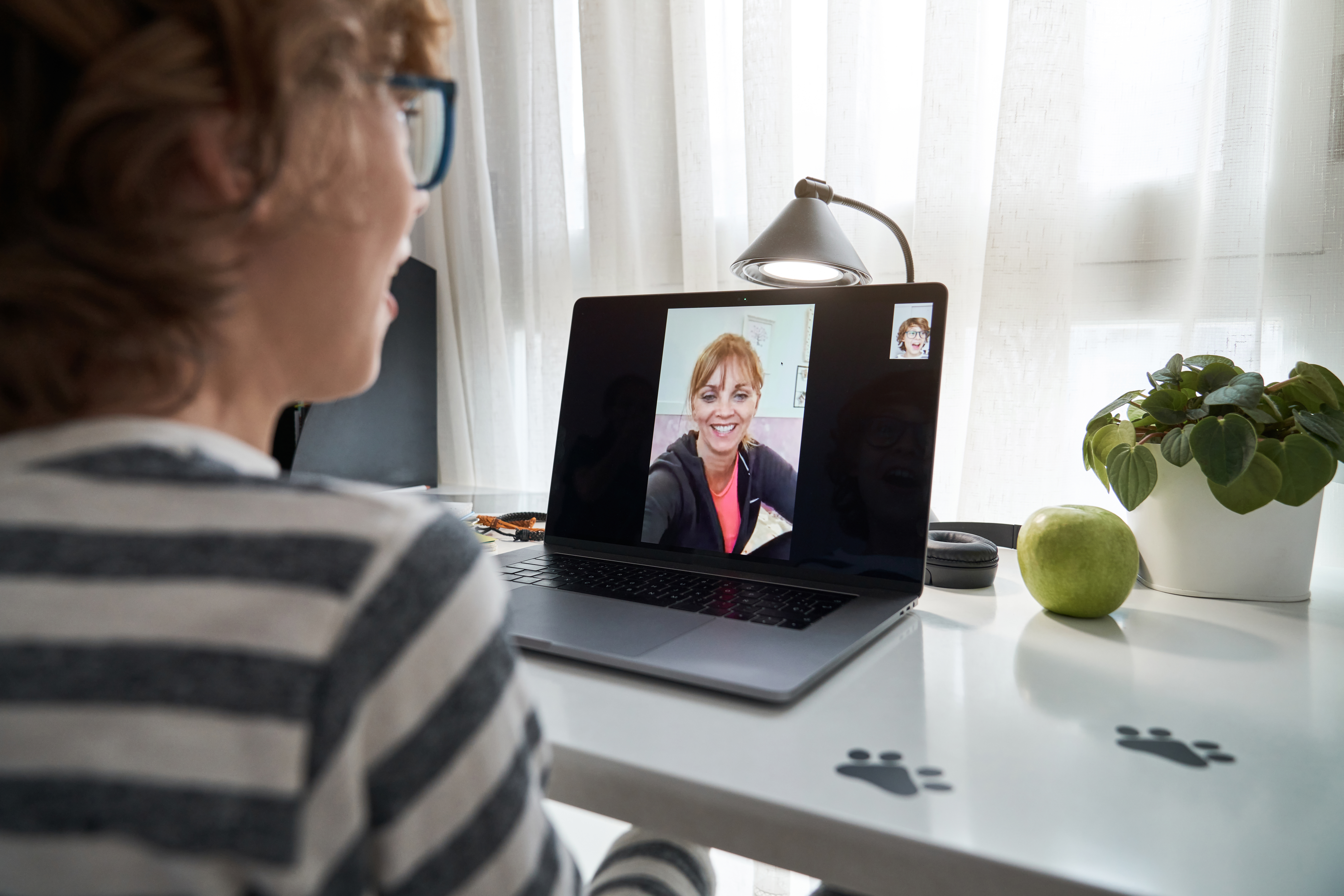 A person in a virtual therapy session on their laptop.