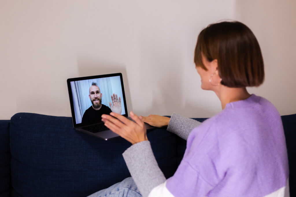 A person in a virtual therapy session on their laptop.